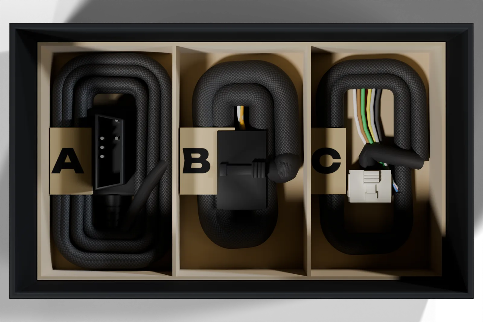 Looking down into the open FusionDrive box: the harness tray with harnesses A, B and C coiled in their bays